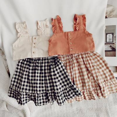 Girls suit with short suspender top and plaid skirt