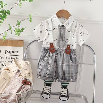 2023 new summer Korean style children's clothing for boys and girls smiling shirt suspenders two-piece summer clothing children's suit trendy