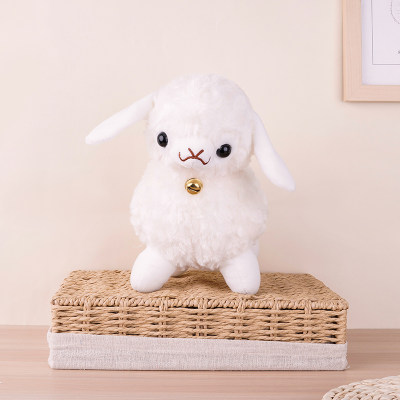 A cute little lamb stuffed sheep animal with a bell