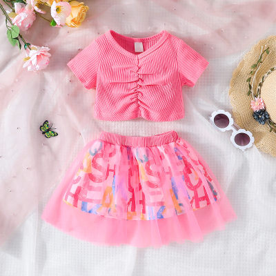 2-piece Baby Girl Solid Color Short Sleeve Top & Allover Letter Printed Mesh Patchwork Skirt