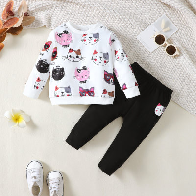 Conjunto de blusa de malha preta com estampa de gato, gola redonda e manga comprida e calça de malha preta com estampa de gato