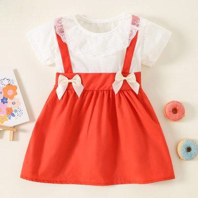 Vestido de manga corta con decoración de lazo empalmado de encaje de retazos de bloque de color de algodón puro para niña pequeña