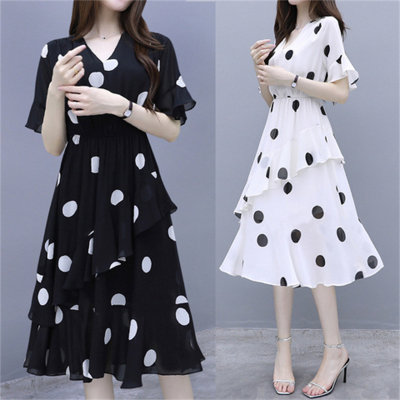 Polka dot plus size dress is loose and covers the belly