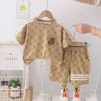 Summer fashionable children's short-sleeved suit with rhombus letters printed all over the street. Trendy new summer short-sleeved suit for boys.  Khaki