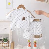 Summer fashionable children's short-sleeved suit with rhombus letters printed all over the street. Trendy new summer short-sleeved suit for boys.  White